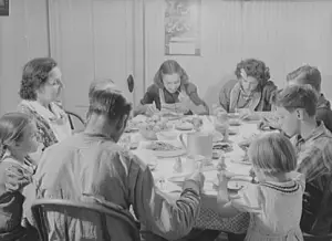 Not quite a reveillon: Franco-American potato farmer and his family eat dinner in Wallagrass, Maine. Photo courtesy Library of Congress.