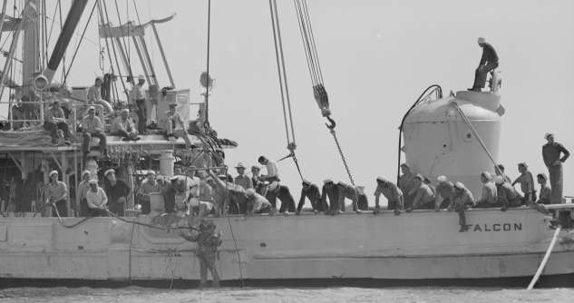A diver from the Falcon prepares to enter the water to help guide the rescue chamber (right) to the USS Squalus. Courtesy of the Boston Public Library, Leslie Jones Collection.