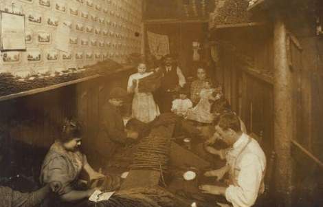 Cigar factory at 205 Atwells Ave. in Providence, R.I. Hine wrote, 205 Atwells Av., Providence, R.I. "Eight year old boy and ten year old girl are stripping. This room is the living, -sleeping-and-working room and adjoins the store. Nov 23, 1912. Very dirty and ill-kept."