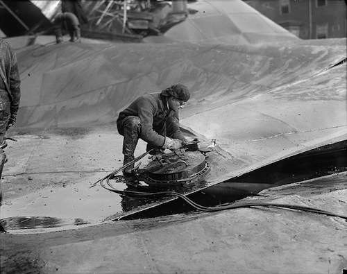 Cutting the tank with acetylene torch 3 days after the disaster. Photo courtesy Boston Public Library, Leslie Jones Collection.