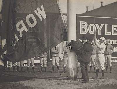 Boston Americans player-manager Jimmy Collins raises the World Championship flag before the 1904 home opener. Photo courtesy Boston Public Library, Michael McGreevey collection.