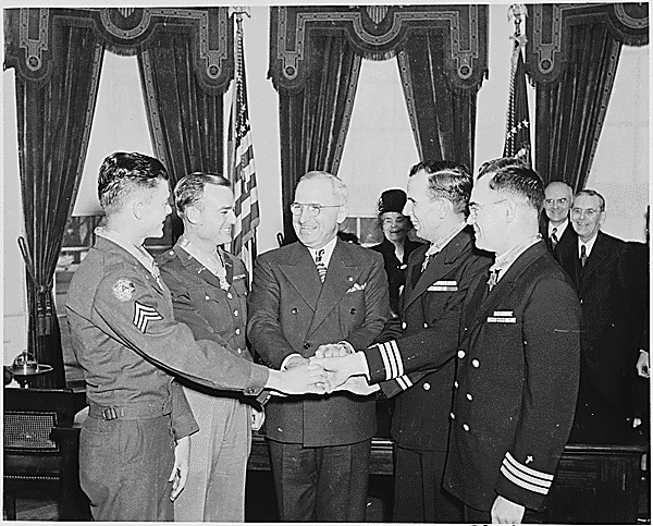 President Harry Truman awards Father O'Callahan (far right) the Medal of Honor. 