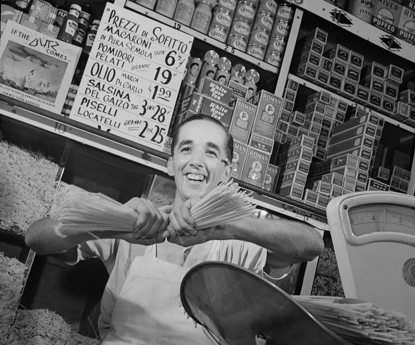Charles Ruggiero, clerk in a grocery store in New York's Italian section, wishes the handful of spaghetti he is breaking were Mussolini's neck. Photo courtesy Library of Congress.